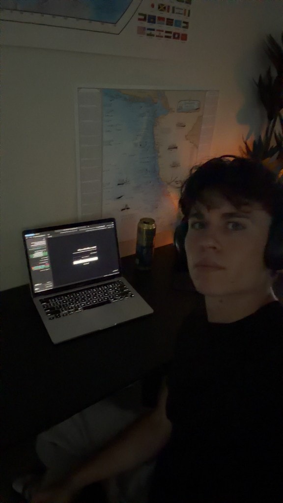 Hudson Ferreira working late at a desk with laptop and headphones